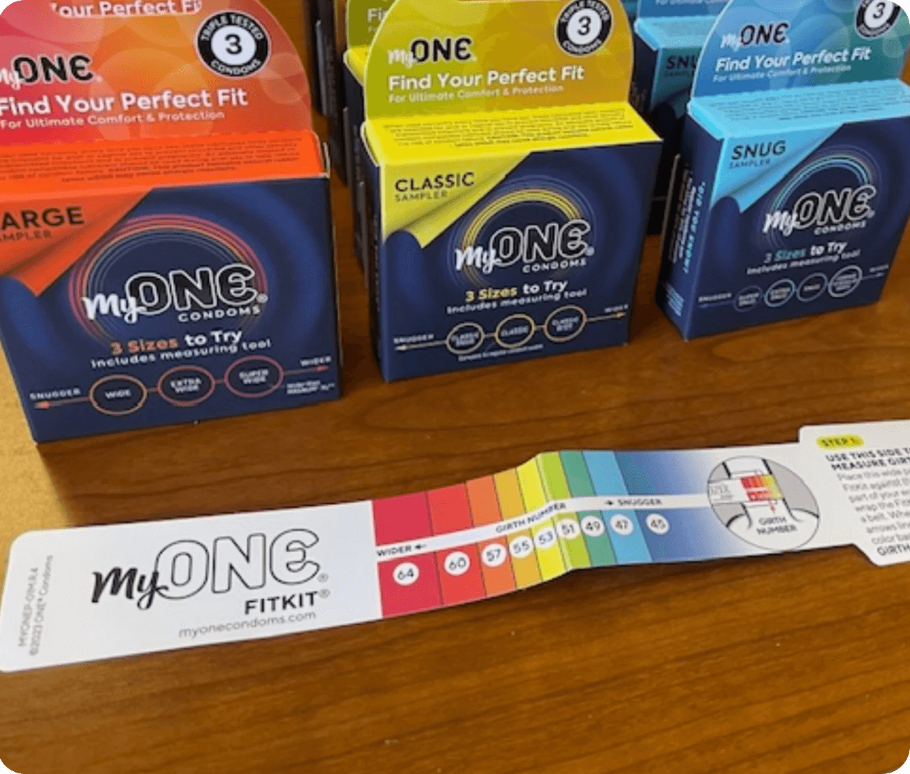 MyONE condon packaging with a FitKit on a wooden surface