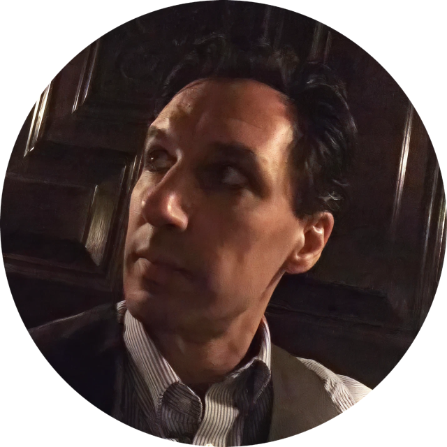 man with black hair looking away with wood wall background