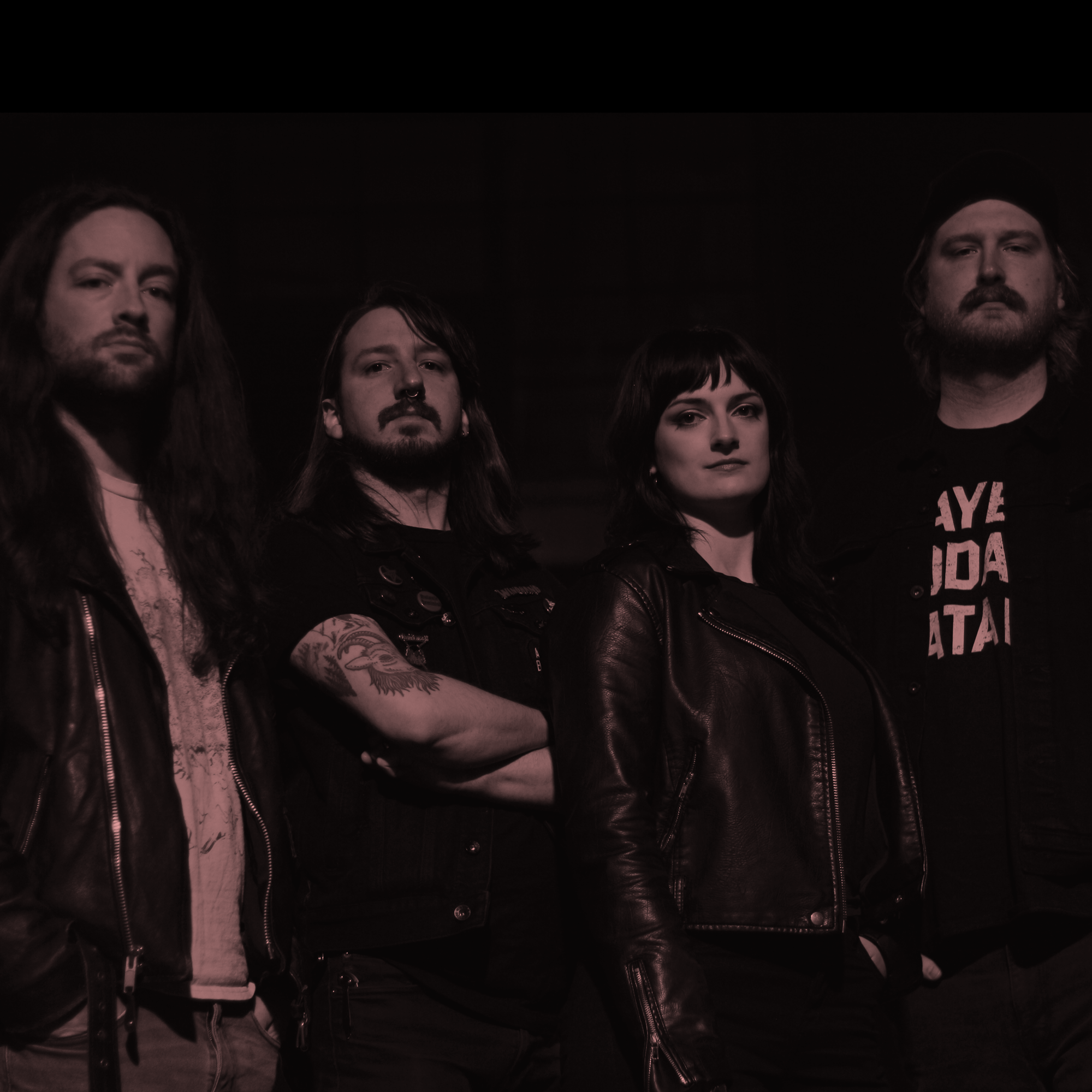 Image of Slow Goat - a new ONE on Stage band. Four people dressed in black looking at camera.